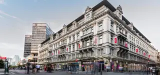 Exterior view of Grand Casino Brussels Viage with people walking by.
